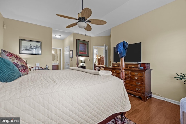 bedroom featuring wood finished floors, baseboards, ensuite bath, and ceiling fan