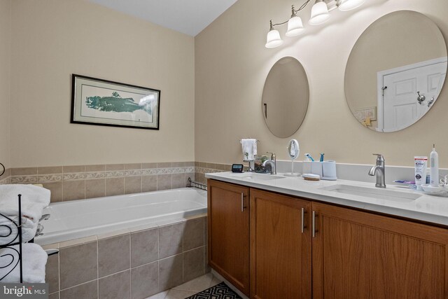 full bathroom with a bath, double vanity, and tile patterned floors