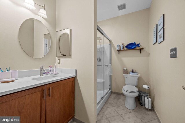 full bath with vanity, toilet, a shower stall, tile patterned floors, and baseboards