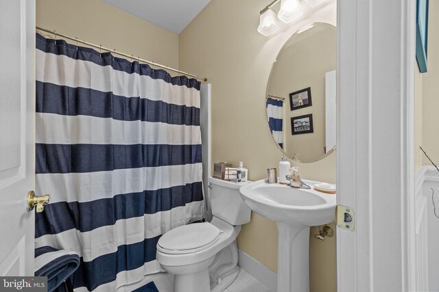 full bathroom with toilet, curtained shower, and tile patterned floors