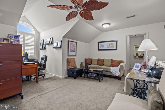 carpeted home office with vaulted ceiling, a ceiling fan, and baseboards