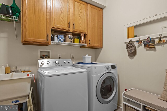 laundry area featuring independent washer and dryer and cabinet space