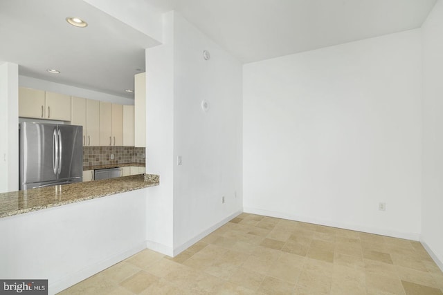 kitchen with appliances with stainless steel finishes, backsplash, recessed lighting, baseboards, and stone counters
