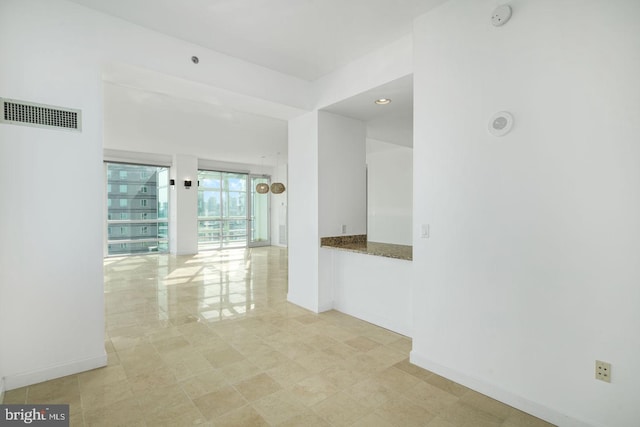 corridor featuring baseboards and recessed lighting