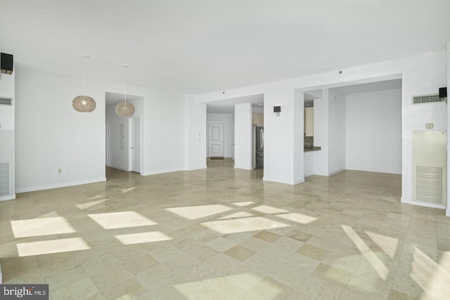 spare room with baseboards