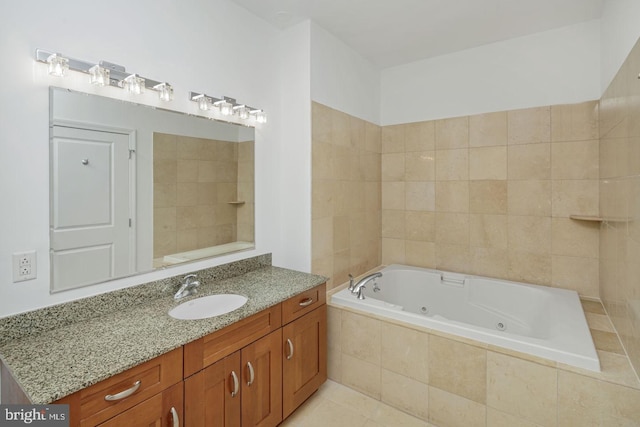 full bathroom featuring a whirlpool tub, vanity, and tile patterned floors