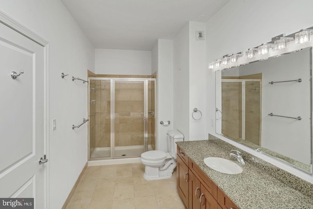 full bathroom featuring a stall shower, vanity, toilet, and tile patterned floors