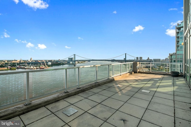view of patio / terrace with a water view and a balcony