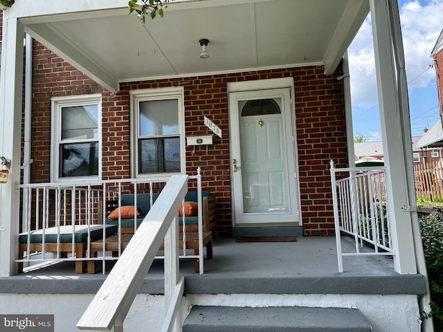 1075 Elm, Halethorpe, MD 21227 - property entrance featuring covered porch and brick siding
