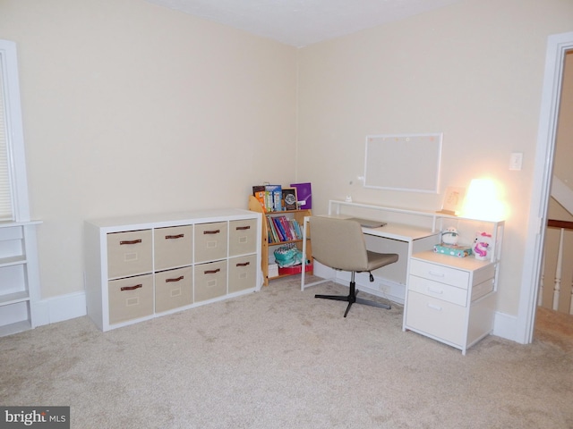 office space with light carpet and baseboards