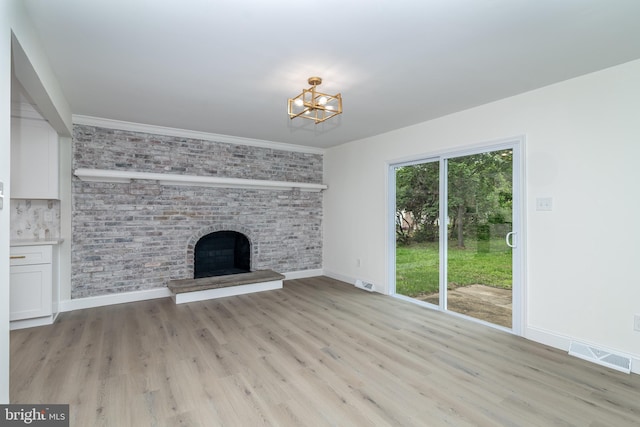 203 Shenandoah Rd, Cinnaminson, NJ 08077 - unfurnished living room featuring a chandelier, a fireplace, baseboards, light wood finished floors, and brick wall