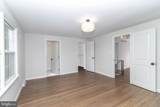 203 Shenandoah Rd, Cinnaminson, NJ 08077 - unfurnished bedroom featuring wood finished floors, baseboards, a walk in closet, and a closet