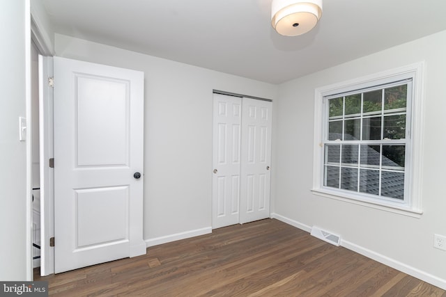 203 Shenandoah Rd, Cinnaminson, NJ 08077 - unfurnished bedroom with dark wood-style flooring, baseboards, and a closet