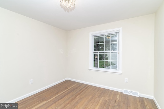 203 Shenandoah Rd, Cinnaminson, NJ 08077 - spare room featuring baseboards, wood finished floors, and a chandelier