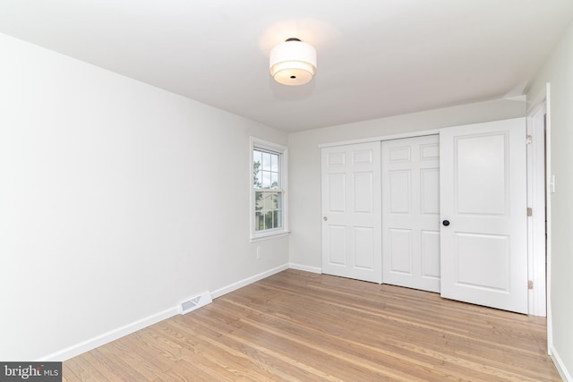 203 Shenandoah Rd, Cinnaminson, NJ 08077 - unfurnished bedroom featuring light wood-style flooring, baseboards, and a closet