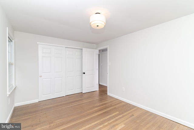 203 Shenandoah Rd, Cinnaminson, NJ 08077 - unfurnished bedroom featuring baseboards, light wood-style floors, and a closet