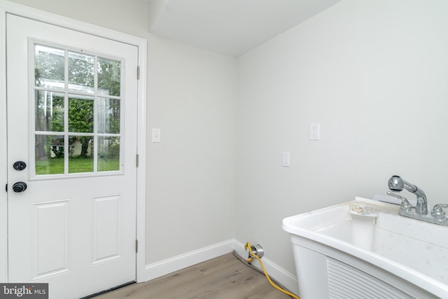 203 Shenandoah Rd, Cinnaminson, NJ 08077 - laundry room with light wood-style flooring, baseboards, and a sink