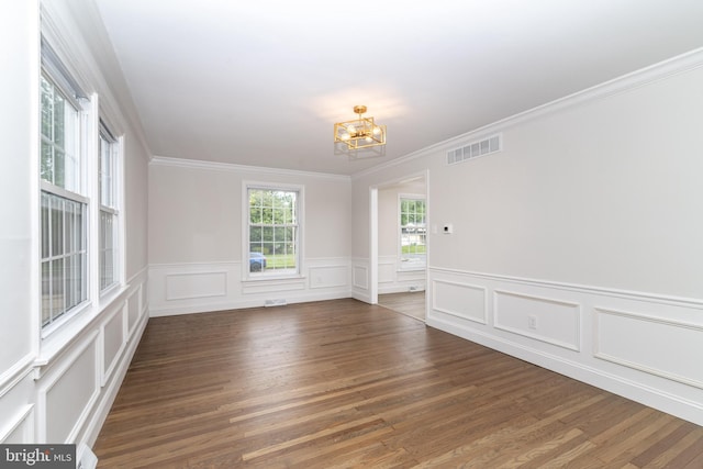 203 Shenandoah Rd, Cinnaminson, NJ 08077 - unfurnished room featuring a chandelier, crown molding, wood finished floors, wainscoting, and a decorative wall