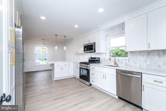 203 Shenandoah Rd, Cinnaminson, NJ 08077 - kitchen with appliances with stainless steel finishes, a sink, a peninsula, white cabinets, and tasteful backsplash