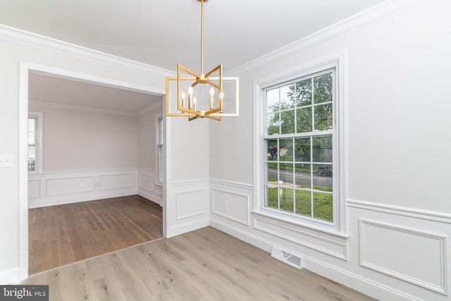 203 Shenandoah Rd, Cinnaminson, NJ 08077 - unfurnished dining area with a chandelier, ornamental molding, wood finished floors, wainscoting, and a decorative wall