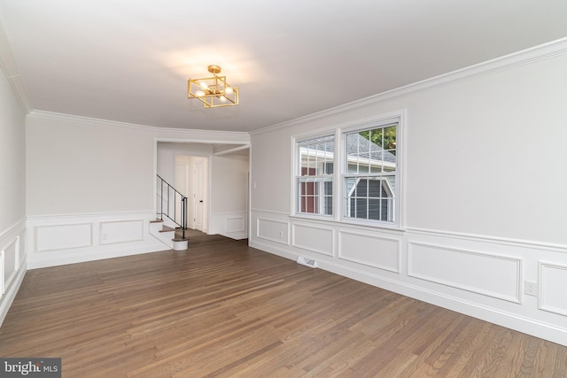 203 Shenandoah Rd, Cinnaminson, NJ 08077 - unfurnished dining area featuring a chandelier, stairway, ornamental molding, wood finished floors, and a wainscoted wall