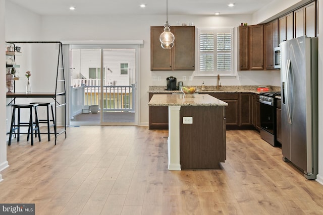 340 Shipyard Dr, Cambridge, MD 21613 - kitchen with appliances with stainless steel finishes, a sink, a center island, decorative light fixtures, and light stone counters