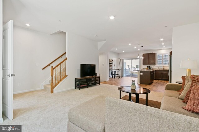 340 Shipyard Dr, Cambridge, MD 21613 - living room with recessed lighting, light carpet, baseboards, and stairway