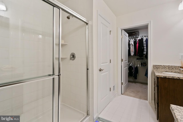 340 Shipyard Dr, Cambridge, MD 21613 - bathroom with a stall shower, vanity, a spacious closet, and tile patterned flooring