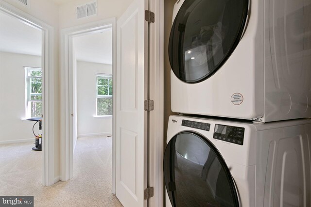 340 Shipyard Dr, Cambridge, MD 21613 - laundry area featuring estacked washer and dryer, light carpet, and baseboards