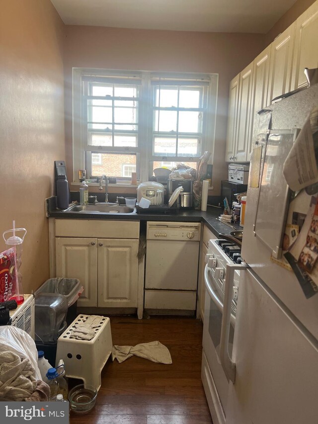 732 Melon Pl Unit D, Philadelphia, PA 19123 - kitchen featuring white appliances, a sink, hardwood / wood-style floors, dark countertops, and white cabinetry