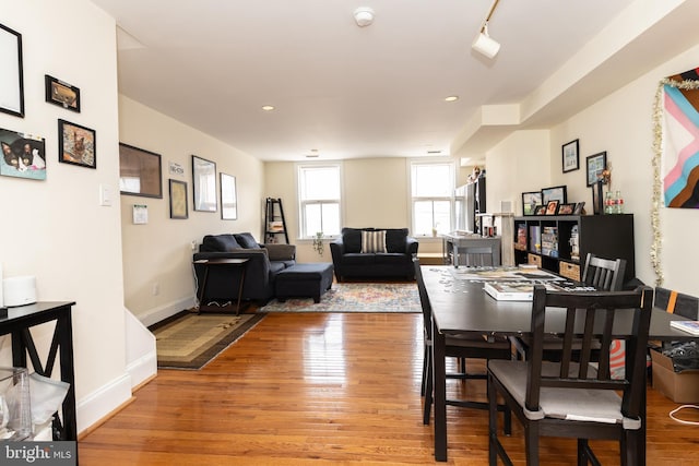 dining area featuring light wood-type flooring, baseboards, and recessed lighting