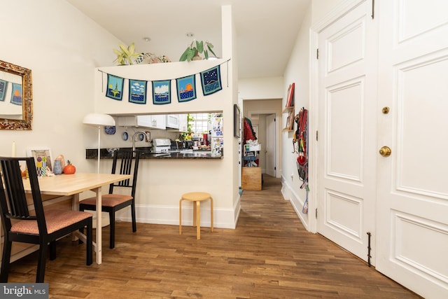 dining area with wood finished floors and baseboards
