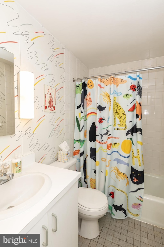 full bathroom featuring tile patterned flooring, vanity, toilet, and shower / bath combo with shower curtain