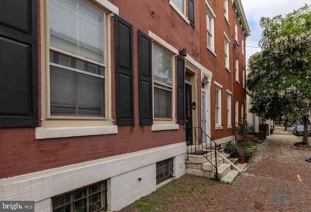 view of side of property with brick siding and entry steps