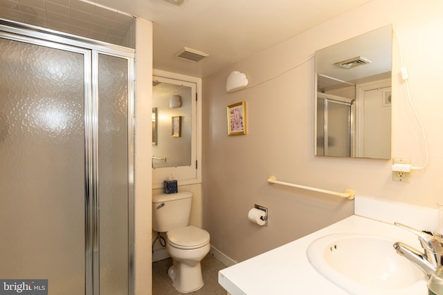 full bathroom featuring a stall shower, toilet, tile patterned floors, baseboards, and vanity