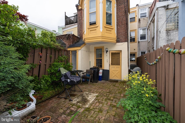back of property with stucco siding, fence, a patio area, and central air condition unit