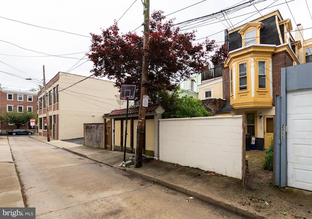 view of property exterior with fence and brick siding