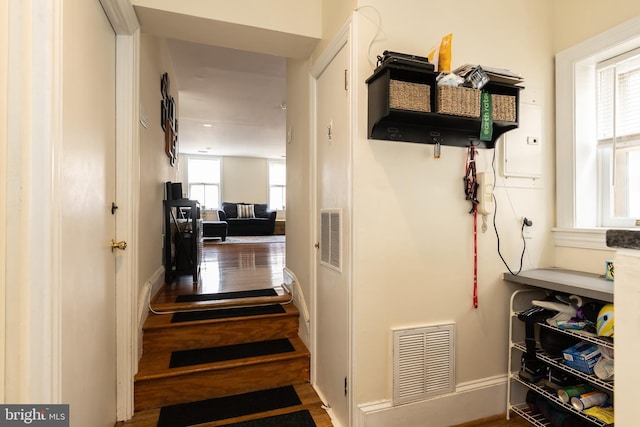 mudroom with wood finished floors and baseboards