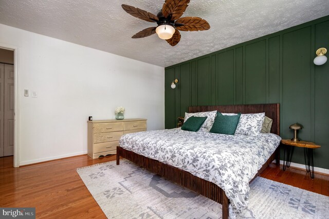 4783 Jaybird Ct, Waldorf, MD 20603 - bedroom featuring baseboards, wood finished floors, a textured ceiling, and a ceiling fan