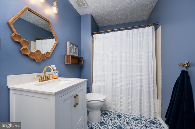 4783 Jaybird Ct, Waldorf, MD 20603 - full bathroom featuring toilet, vanity, a shower with shower curtain, a textured ceiling, and tile patterned flooring