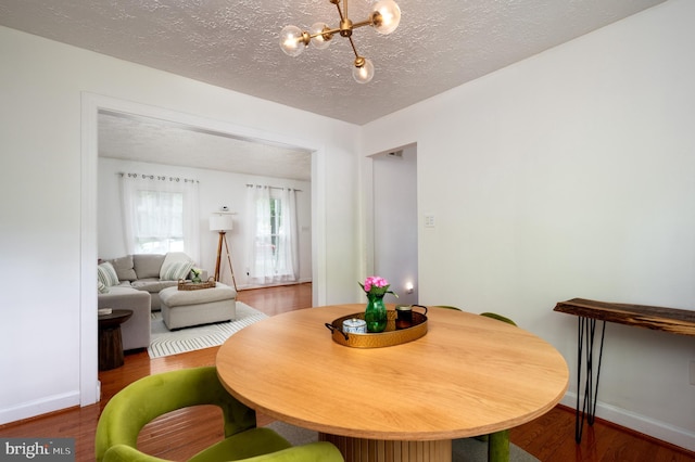 4783 Jaybird Ct, Waldorf, MD 20603 - dining room featuring a chandelier, wood finished floors, baseboards, and a textured ceiling