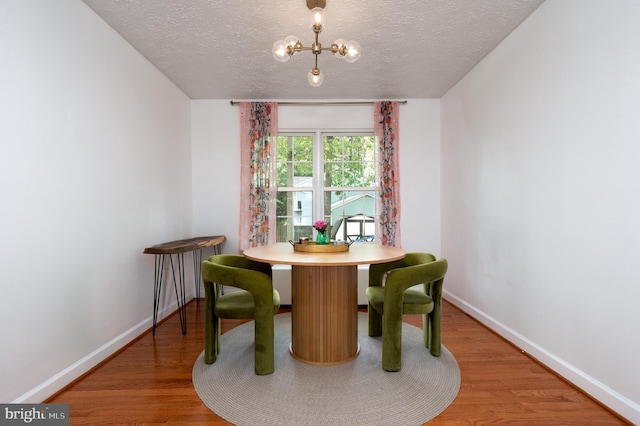 4783 Jaybird Ct, Waldorf, MD 20603 - dining space featuring a textured ceiling, baseboards, wood finished floors, and a chandelier