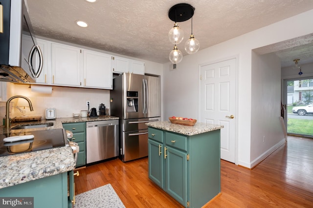 4783 Jaybird Ct, Waldorf, MD 20603 - kitchen with stainless steel appliances, a sink, light wood-type flooring, white cabinets, and green cabinetry