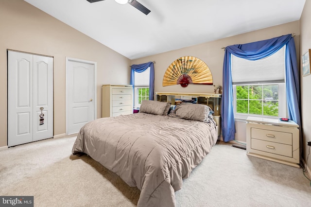 carpeted bedroom with vaulted ceiling, ceiling fan, baseboards, and a closet