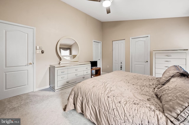 bedroom featuring lofted ceiling, light carpet, ceiling fan, and baseboards
