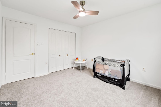 bedroom featuring carpet flooring, baseboards, a closet, and ceiling fan