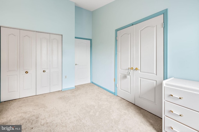 unfurnished bedroom featuring carpet flooring and a closet