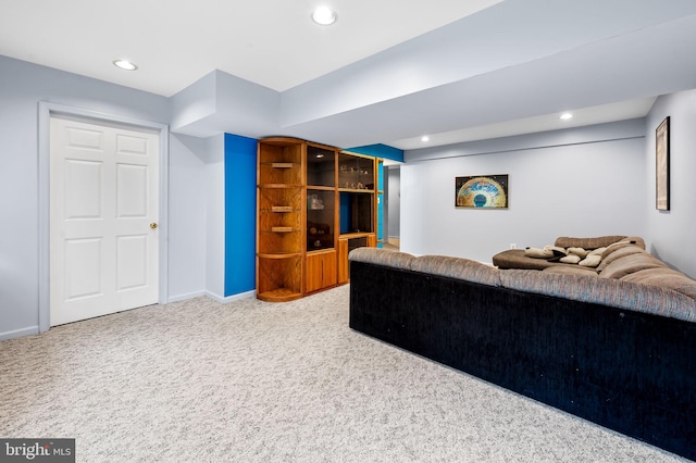 carpeted living area featuring recessed lighting and baseboards