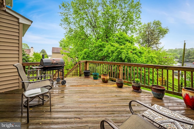 wooden terrace with a grill