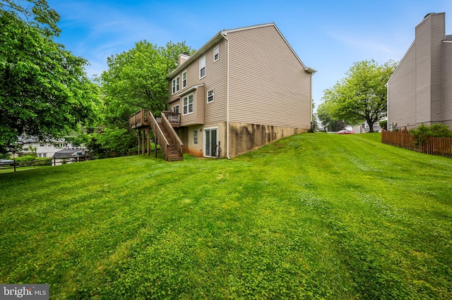 rear view of house featuring stairs, a deck, and a chimney